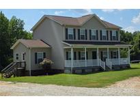 Charming two-story home featuring a welcoming front porch and well-maintained lawn at 550 Baker Mill Rd, Cleveland, NC 27013