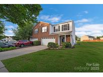 Charming two-story home with a well-manicured lawn, two-car garage, and landscaped front yard at 6340 Ziegler Ln # 148-A, Charlotte, NC 28269