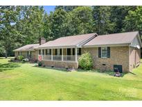 Charming brick ranch home with a large porch and lush lawn, perfect for outdoor living at 6601 Charlotte Hwy, York, SC 29745