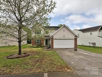 Charming two-story home with a two car garage and landscaped front yard at 7024 Sunman Rd, Charlotte, NC 28216