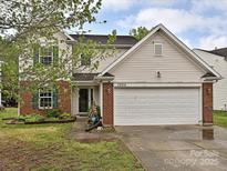 Charming two-story home features brick accents, a two-car garage, and a well-maintained front yard in a nice neighborhood at 7024 Sunman Rd, Charlotte, NC 28216