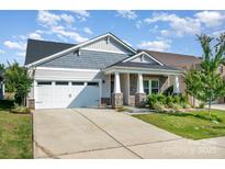 Charming home featuring stone accents, a two-car garage, and a well-manicured lawn at 9311 Dunwich Dr, Gastonia, NC 28056