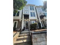 Charming townhome exterior featuring a well-maintained yard and inviting entryway with stairs at 1013 Park West Dr # 5, Charlotte, NC 28209
