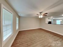 Bright, open living room with wood floors and a ceiling fan at 115 Dove Sw Ave, Concord, NC 28025