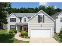 Charming two-story home with a well-manicured front yard and a two-car garage offers great curb appeal at 12341 Mcallister Park Dr, Charlotte, NC 28277