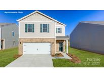 Charming two-story home featuring a brick and siding exterior, attached garage, and well-manicured lawn at 1339 37Th Avenue Ne Ln, Hickory, NC 28601