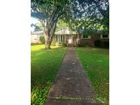Charming brick home featuring a covered entrance and a walkway leading to the front door at 1628 Cecelia Dr, Gastonia, NC 28054