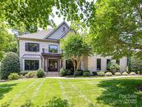 Stunning brick home boasts lush landscaping and a welcoming front yard at 18618 Rollingdale Ln, Davidson, NC 28036
