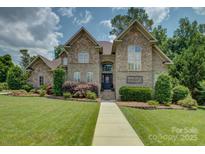 Charming stone and brick home with well-manicured lawn and beautiful landscaping at 213 Cowboys Cir, Rock Hill, SC 29732