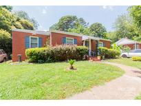 Charming brick home with a well-maintained lawn and blue shutters offers classic curb appeal at 3037 Marlowe Ave, Charlotte, NC 28208
