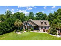 Charming home featuring a beautifully landscaped front yard and stone accents on the facade at 313 Sunset View Ct, York, SC 29745