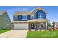 Charming two-story home featuring stone accents, a two-car garage, and a welcoming front porch at 4178 Skyboat Cir, Fort Mill, SC 29715
