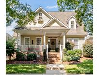 Charming home featuring a welcoming front porch, manicured landscaping, and a classic architectural style at 5572 Yorke Nw St, Concord, NC 28027