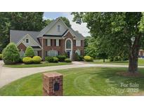 Beautiful brick home with a well-manicured lawn and mature trees offers great curb appeal at 61 38Th Nw Ave, Hickory, NC 28601