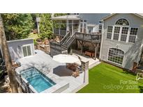 This backyard boasts a pool, deck, and screened-in porch with plenty of space for outdoor entertaining at 6800 Augustine Way, Charlotte, NC 28270