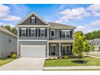 Charming two-story home with gray siding, black shutters, and a well-manicured front lawn at 7025 Amberhouse Dr, Charlotte, NC 28212