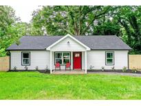 Charming home with a bright red door and a well-manicured front lawn at 9208 Detroiter Dr, Huntersville, NC 28078