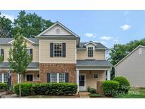 Charming townhome with brick accents and manicured landscaping at 1326 Anthem Ct, Charlotte, NC 28205