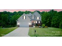 Charming two-story home with attached garage, lush lawn, and well-maintained landscaping at 139 Sheep Path Dr, Mooresville, NC 28115