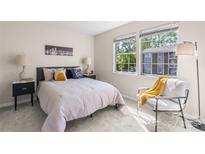Bright bedroom features two large windows, modern decor, and soft carpet flooring at 1620 #K Arlyn Cir # K, Charlotte, NC 28213