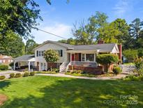Charming home featuring a well-manicured lawn, brick accents, and a welcoming front porch at 1632 Kimberly Dr, Gastonia, NC 28052