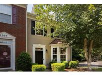 Charming townhome with black front door, bay window, and beautiful landscape at 2273 Aston Mill Pl, Charlotte, NC 28273