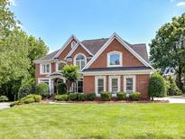 Beautiful brick home with manicured lawn and mature landscaping creates a welcoming curb appeal at 27246 Preston Pl, Fort Mill, SC 29707