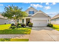 Charming home with a well-manicured lawn, tree and two-car garage at 3835 Norman View Dr, Sherrills Ford, NC 28673