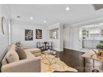 Bright living room boasts a stylish sofa, unique coffee table, and hardwood floors at 404 Wakefield Dr # C, Charlotte, NC 28209