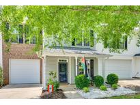 Charming two-story home with a quaint front porch and well-manicured landscaping at 713 Torrey Pines Ln, Fort Mill, SC 29715