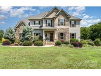 Charming home featuring stone accents, a landscaped front yard, and inviting curb appeal at 7805 Crooked Creek Church Rd, Monroe, NC 28110