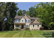Charming two-story home featuring a well-manicured lawn and inviting curb appeal at 8402 Aspen Ct, Charlotte, NC 28227