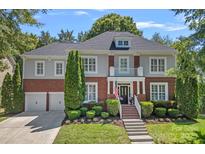 Charming two-story home featuring a well-manicured lawn, brick accents, and an inviting entryway at 9427 Gilpatrick Ln # 5, Huntersville, NC 28078