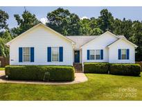 Charming single-story home with white siding, blue shutters, and a well-manicured lawn at 958 Hillard Ln, Lincolnton, NC 28092
