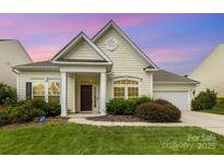 Charming single-story home featuring a well-manicured lawn, inviting entrance, and attached garage at 1116 Arnott Ln, Matthews, NC 28105