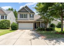 Charming two-story home with a two-car garage, brick accents, and well-manicured landscaping at 13510 Brandon Trail Dr, Charlotte, NC 28213