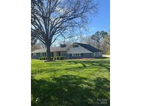 Charming single-story home featuring a lush green lawn, mature tree, and traditional architectural style at 188 Gum Branch Rd # 3, Charlotte, NC 28214
