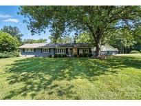 Charming single-story home with a well-manicured lawn and mature trees providing shade at 188 Gum Branch Rd # 3, Charlotte, NC 28214
