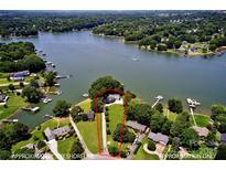 Stunning aerial view of lakefront home with lush landscaping and private dock, approximately 300' shoreline at 188 Ponderosa Cir, Mooresville, NC 28117