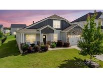 Charming single Gathering home with a well-manicured lawn and inviting front porch at 2296 Idol Rock Dr, Indian Land, SC 29707
