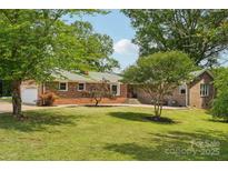 Charming brick home with a well-manicured front yard and mature trees, offering great curb appeal at 327 Johnson Dairy Rd, Mooresville, NC 28115