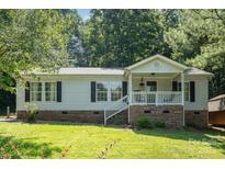 Charming single-Gathering home with a cozy front porch and well-maintained lawn at 394 Link Dr, Iron Station, NC 28080