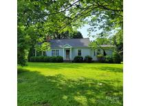 Charming single-story home with a well-maintained lawn and mature trees at 6908 Alexander Rd, Charlotte, NC 28270