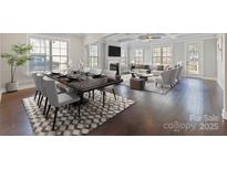 Open-concept living and dining area featuring hardwood floors, modern furniture, fireplace, and plenty of natural light at 704 Kenway Loop, Mooresville, NC 28117