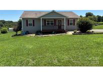 Charming single-story home with a welcoming front porch and meticulously maintained lawn at 72 Helens Way, Taylorsville, NC 28681