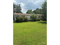 Charming single-story home featuring a well-manicured lawn and inviting front porch at 854 Joseph Antoon Cir, Stanley, NC 28164