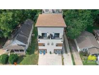 Aerial view of a modern home with white siding and a brown roof surrounded by lush trees in a suburban setting at 1113 Greenleaf Ave # B, Charlotte, NC 28202