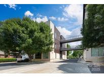 Modern building exterior with connecting skywalks and lush landscaping provides a striking architectural design at 2116 Mcclintock Rd # 122, Charlotte, NC 28205