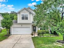 Charming two-story home featuring a well-maintained front yard, attached garage, and traditional architectural details at 3333 Cole Mill Rd, Charlotte, NC 28270