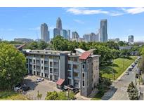Wonderful exterior view of a modern apartment building with city skyline in background at 514 W 10Th St # 302, Charlotte, NC 28202